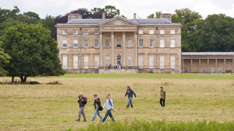 Visitors walking past the house at Attingham Park, Shropshire